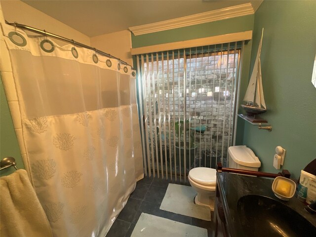 bathroom with crown molding, curtained shower, toilet, vanity, and tile patterned flooring