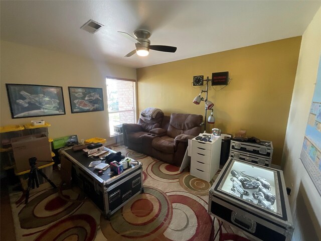 living room featuring visible vents and a ceiling fan