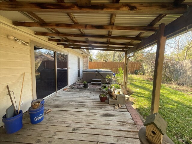 deck featuring a yard, fence, and a hot tub