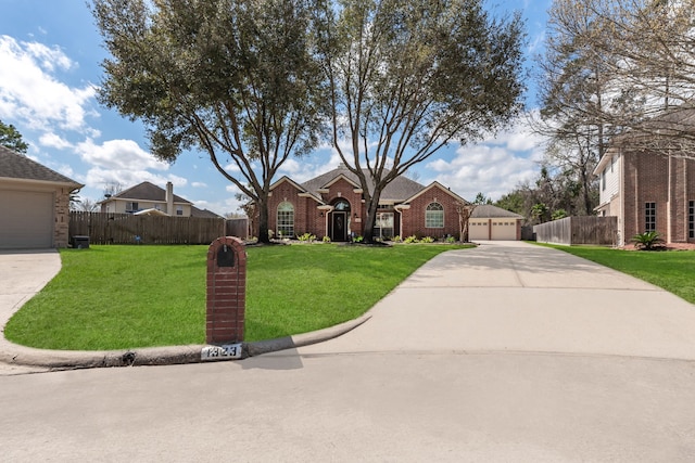 view of front of property featuring brick siding, a front lawn, fence, and a garage