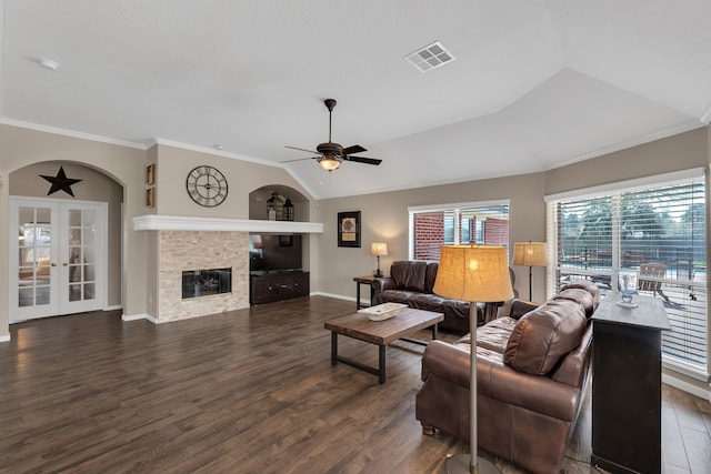 living area featuring ornamental molding, wood finished floors, visible vents, and ceiling fan