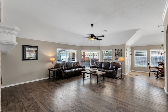 living area featuring visible vents, ceiling fan with notable chandelier, plenty of natural light, and wood finished floors