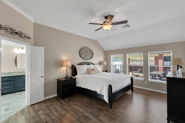 bedroom with visible vents, crown molding, baseboards, lofted ceiling, and dark wood-style floors