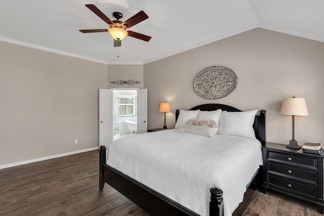 bedroom featuring crown molding, baseboards, lofted ceiling, wood finished floors, and ensuite bath