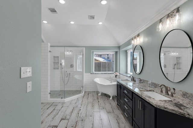 full bath with crown molding, a stall shower, visible vents, and a sink