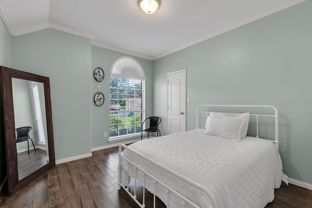 bedroom featuring vaulted ceiling, crown molding, dark wood-style floors, and baseboards