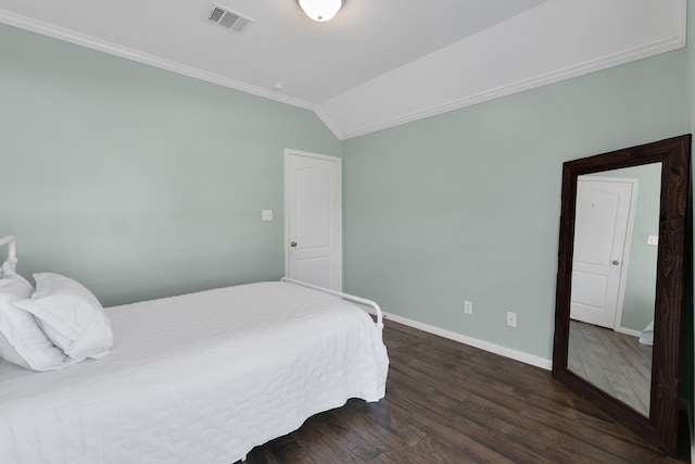 bedroom featuring baseboards, visible vents, lofted ceiling, ornamental molding, and dark wood-type flooring