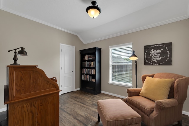 living area with baseboards, lofted ceiling, dark wood-type flooring, and ornamental molding