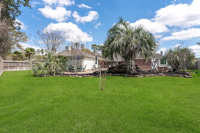 view of yard with a patio and a fenced backyard