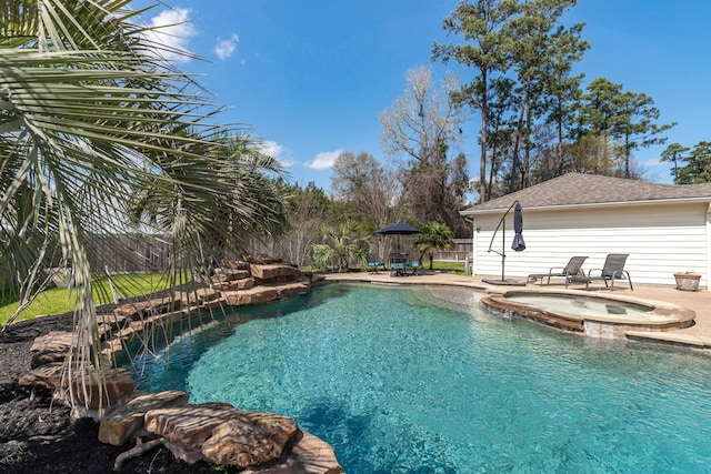 view of pool with a pool with connected hot tub, a fenced backyard, and a patio area