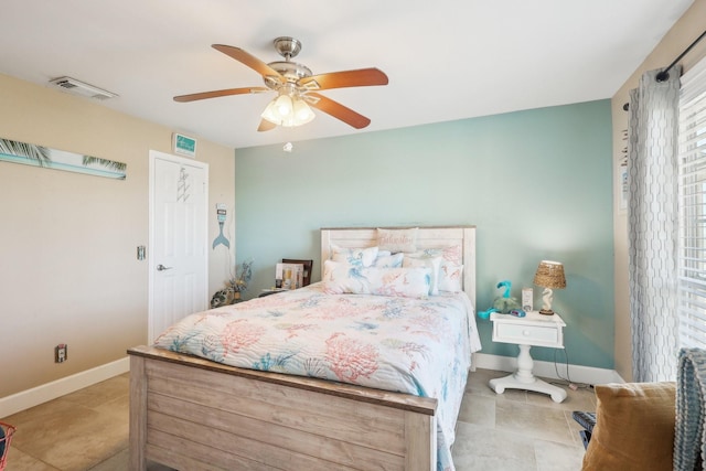 bedroom featuring tile patterned flooring, visible vents, ceiling fan, and baseboards