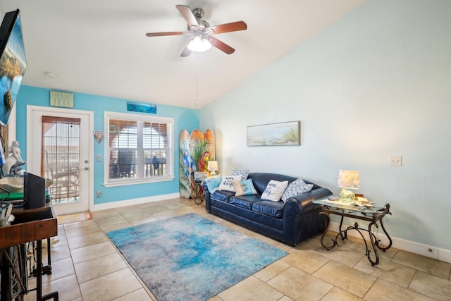 tiled living area featuring lofted ceiling, a ceiling fan, and baseboards