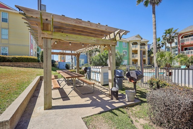 view of patio with a grill, fence, and a pergola