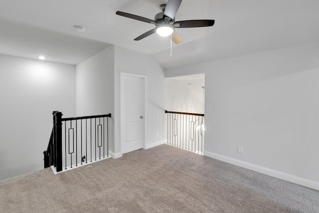 spare room featuring lofted ceiling, carpet floors, and baseboards