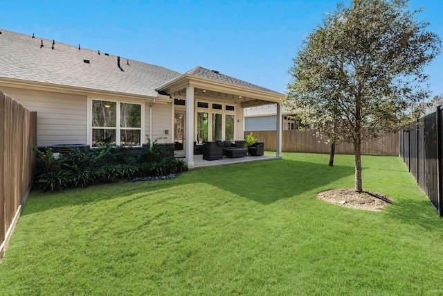 back of property with roof with shingles, a lawn, an outdoor hangout area, a patio area, and a fenced backyard