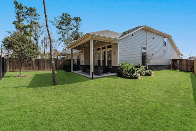 rear view of property with roof with shingles, a patio, a lawn, a fenced backyard, and an outdoor living space