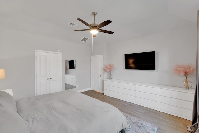 bedroom featuring a closet, visible vents, ceiling fan, and wood finished floors