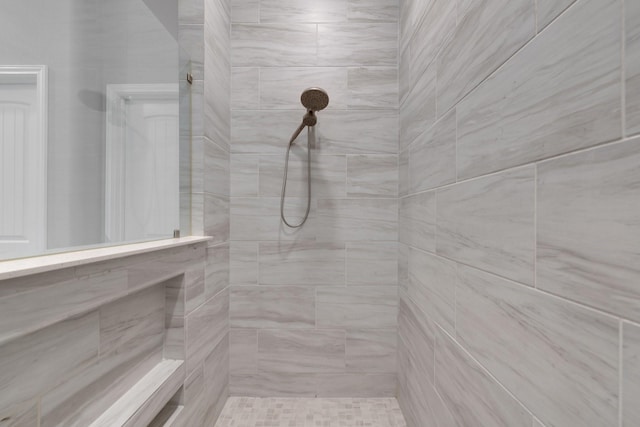 bathroom with a tile shower