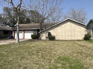 view of side of property with driveway, a lawn, and an attached garage