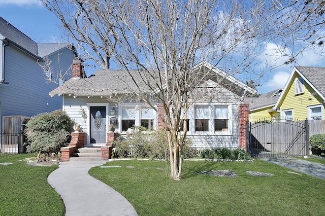 bungalow featuring a front yard, a gate, and fence