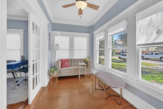 sunroom / solarium featuring french doors and a ceiling fan