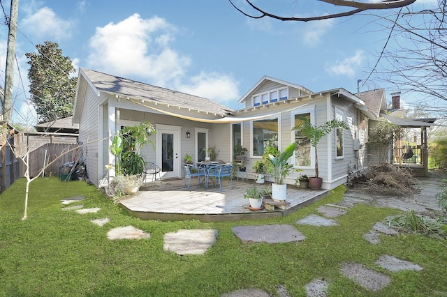 back of house with fence and a lawn