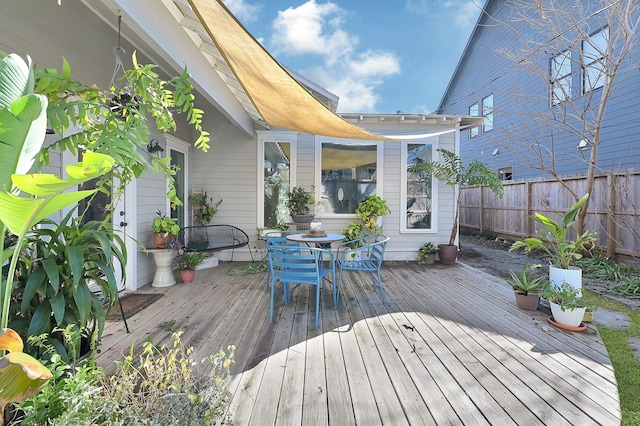 wooden deck featuring outdoor dining area and fence