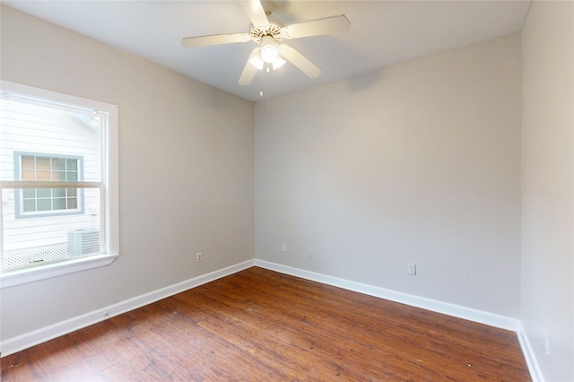 unfurnished room with a ceiling fan, wood finished floors, and baseboards