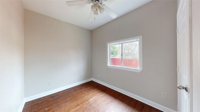 empty room featuring ceiling fan, baseboards, and wood finished floors