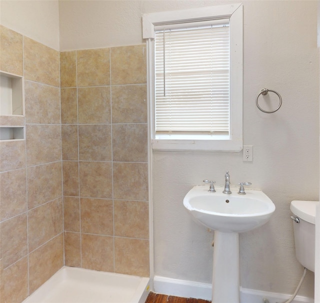 full bathroom with a stall shower and toilet