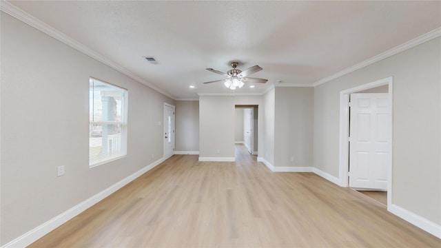 empty room featuring visible vents, crown molding, ceiling fan, baseboards, and light wood-style floors