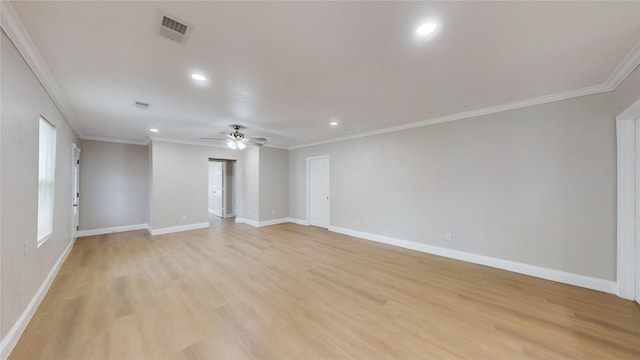 unfurnished room with visible vents, baseboards, light wood-type flooring, ornamental molding, and a ceiling fan