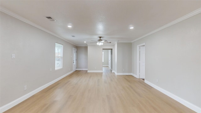 spare room with visible vents, baseboards, light wood-type flooring, ornamental molding, and a ceiling fan