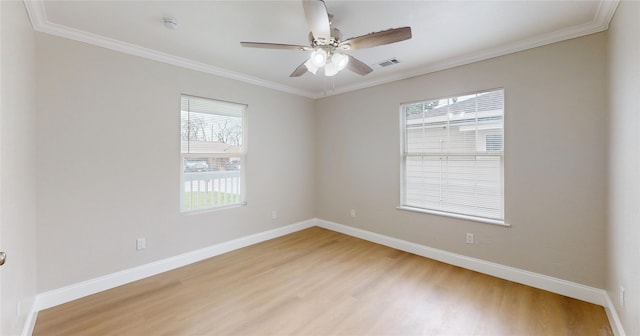 spare room with baseboards, crown molding, light wood-style floors, and a ceiling fan