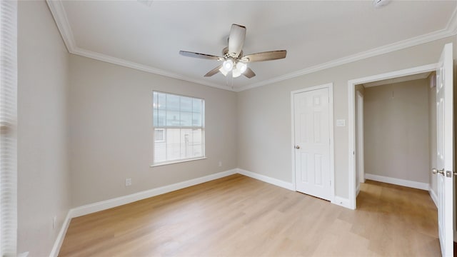 unfurnished bedroom featuring light wood-style flooring, attic access, crown molding, and baseboards