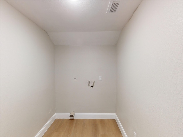 laundry room featuring baseboards, visible vents, hookup for an electric dryer, laundry area, and light wood-style flooring