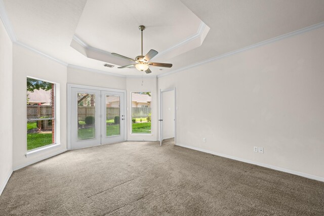 6923 Queensclub Dr, Houston, TX 77069 - carpeted empty room featuring a tray ceiling, crown molding, and a ceiling fan