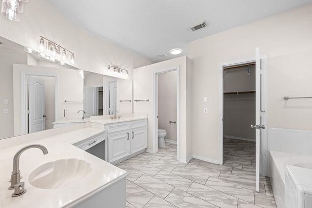 6923 Queensclub Dr, Houston, TX 77069 - full bathroom with marble finish flooring, double vanity, a garden tub, and a spacious closet