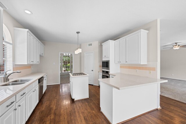 6923 Queensclub Dr, Houston, TX 77069 - kitchen with stainless steel appliances, a center island, tasteful backsplash, light countertops, and white cabinets
