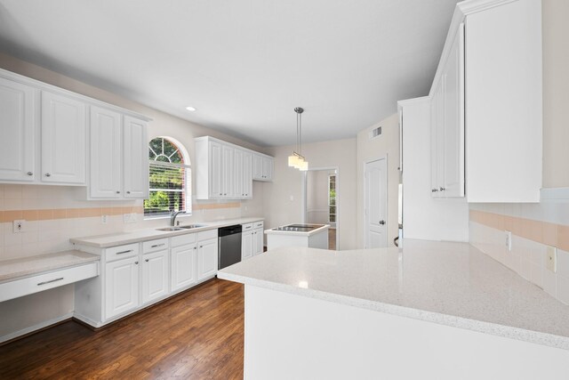 6923 Queensclub Dr, Houston, TX 77069 - kitchen featuring stainless steel dishwasher, white cabinetry, decorative backsplash, dark wood-style floors, and a peninsula