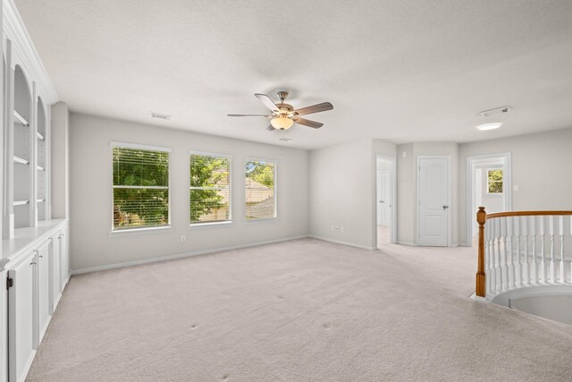 6923 Queensclub Dr, Houston, TX 77069 - unfurnished room featuring healthy amount of natural light, a ceiling fan, and light colored carpet