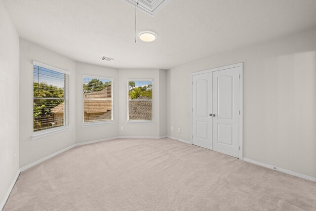 6923 Queensclub Dr, Houston, TX 77069 - unfurnished bedroom featuring carpet flooring, attic access, and a closet