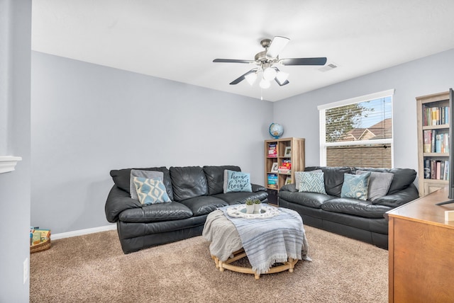 carpeted living room featuring a ceiling fan, visible vents, and baseboards