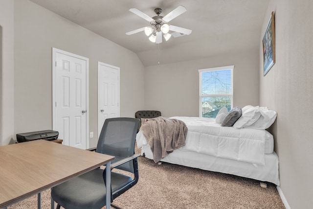 bedroom featuring carpet flooring, two closets, ceiling fan, and vaulted ceiling