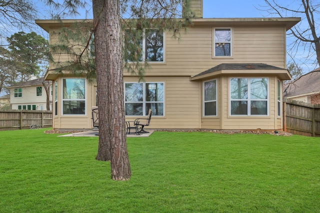 back of house with a yard, a patio area, and fence