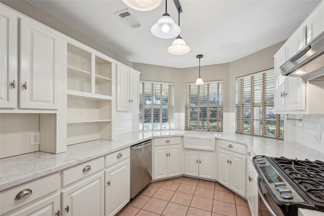 kitchen featuring stainless steel appliances, plenty of natural light, open shelves, and visible vents