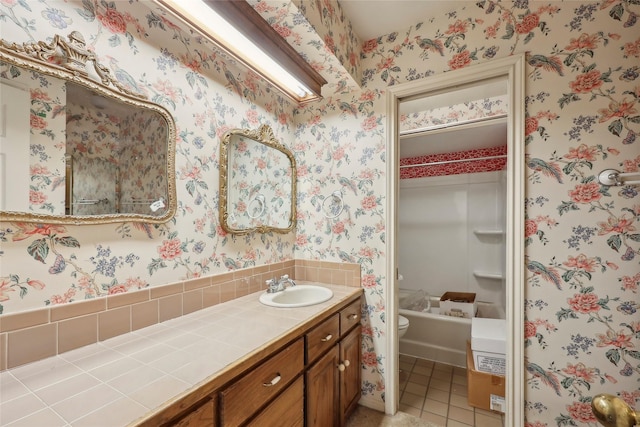 bathroom with vanity, tile patterned flooring, toilet, and wallpapered walls