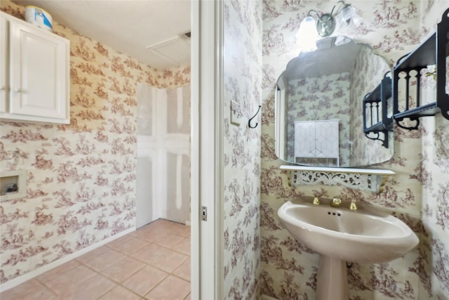 bathroom featuring tile patterned flooring, baseboards, and wallpapered walls