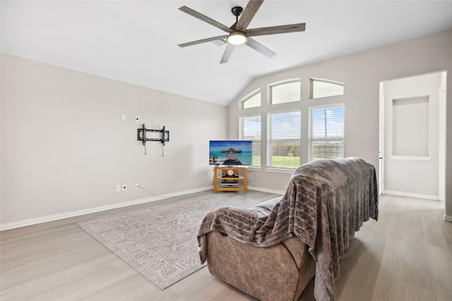 sitting room featuring lofted ceiling, a ceiling fan, baseboards, and wood finished floors