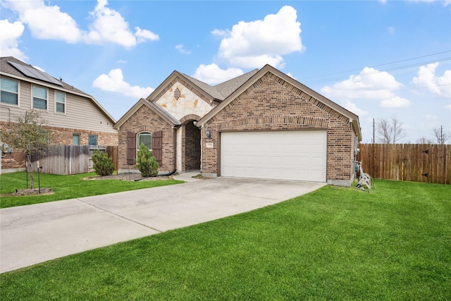 view of front of house with concrete driveway, an attached garage, fence, a front lawn, and brick siding